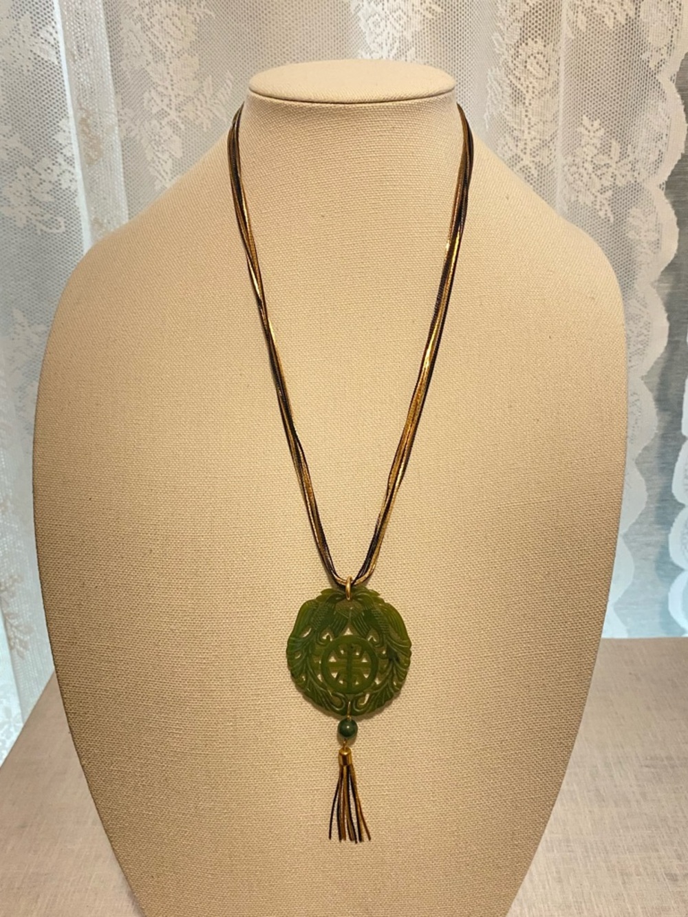 Rich Green Jade Carved Pendant on 10 gold & black chains w/2” tassel & jade bead